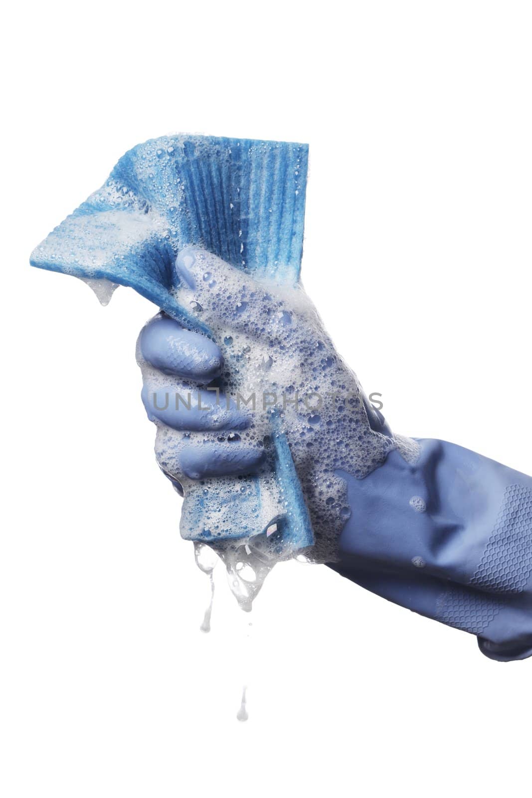 A gloved hand holding a soapy synthetic cleaning cloth.