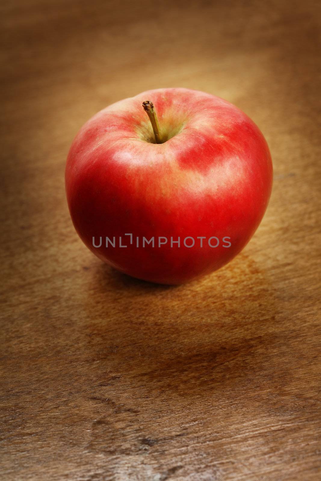 Red apple on brown table