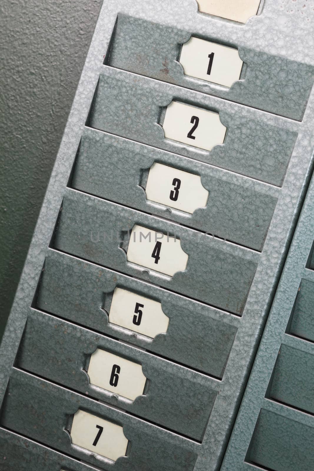 Numbered metallic card slots in an old factory