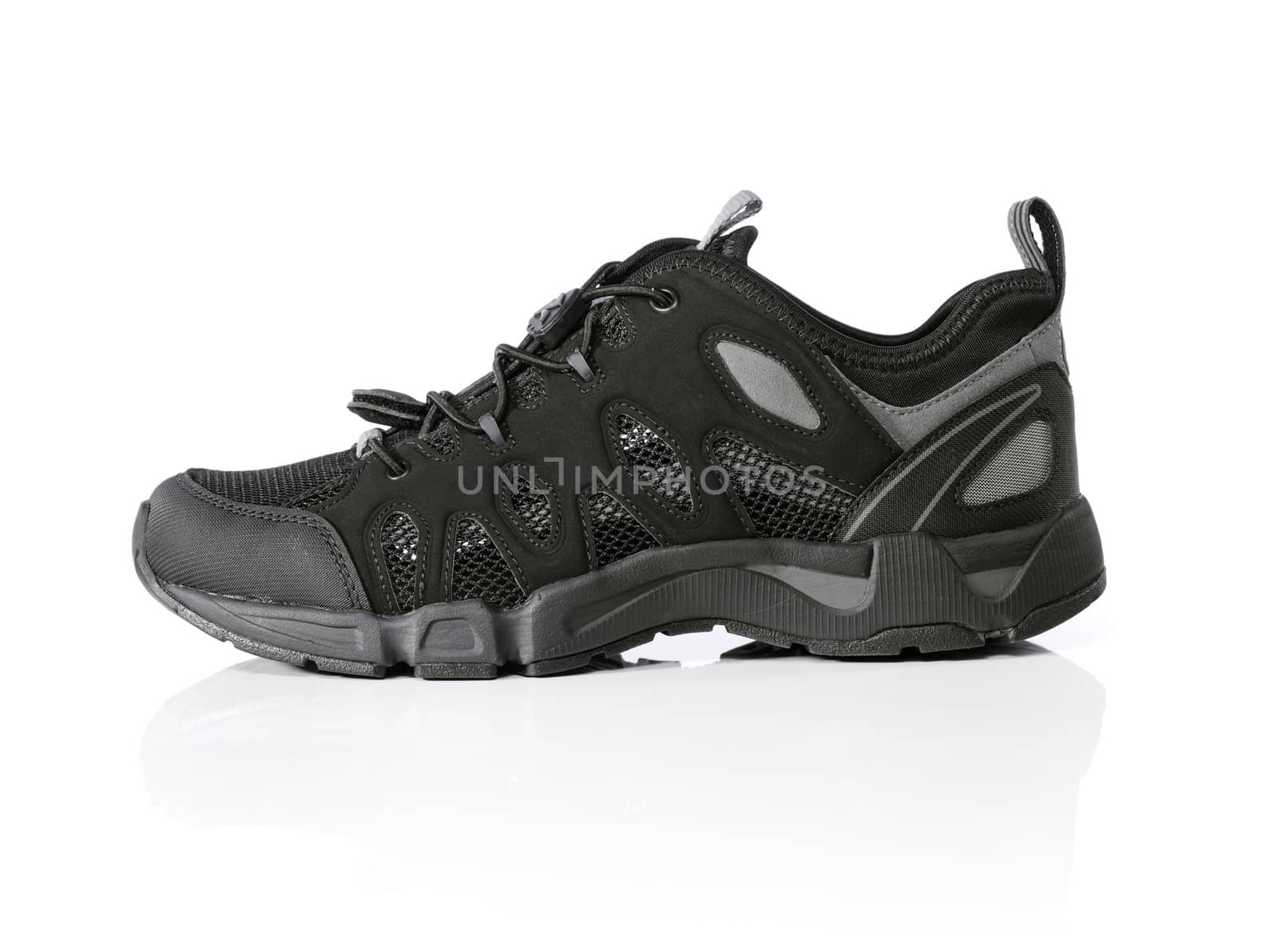 Modern black men's walking shoe isolated on white.