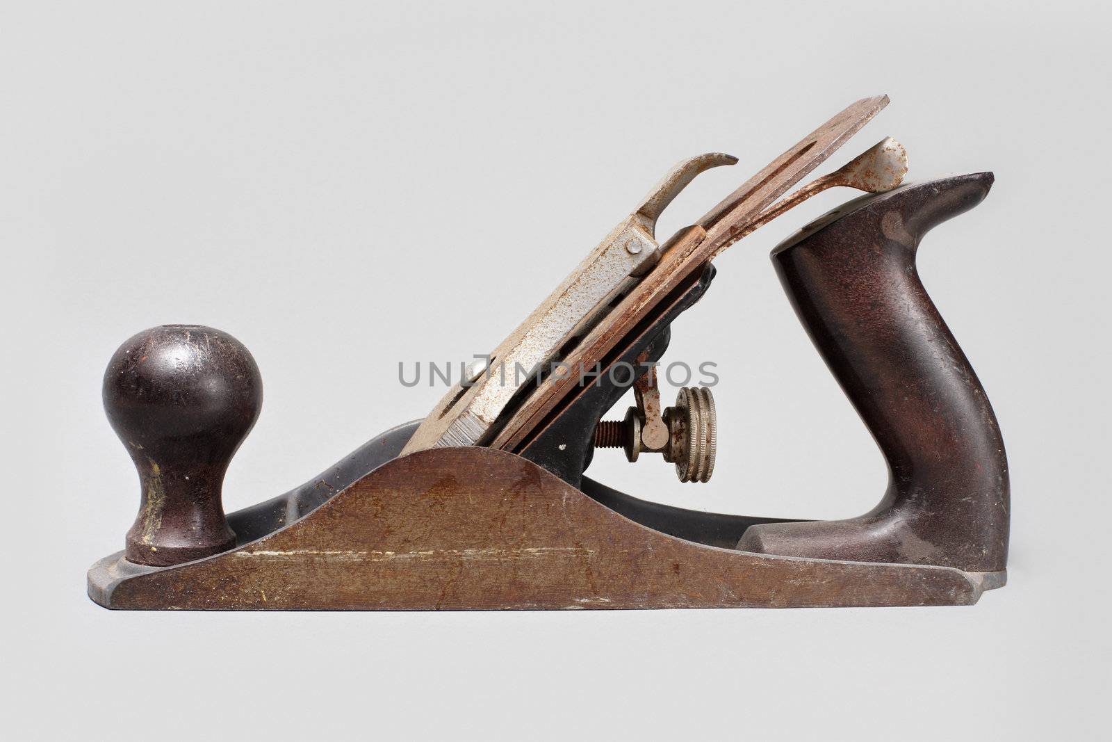 Old hand plane tool on gray background