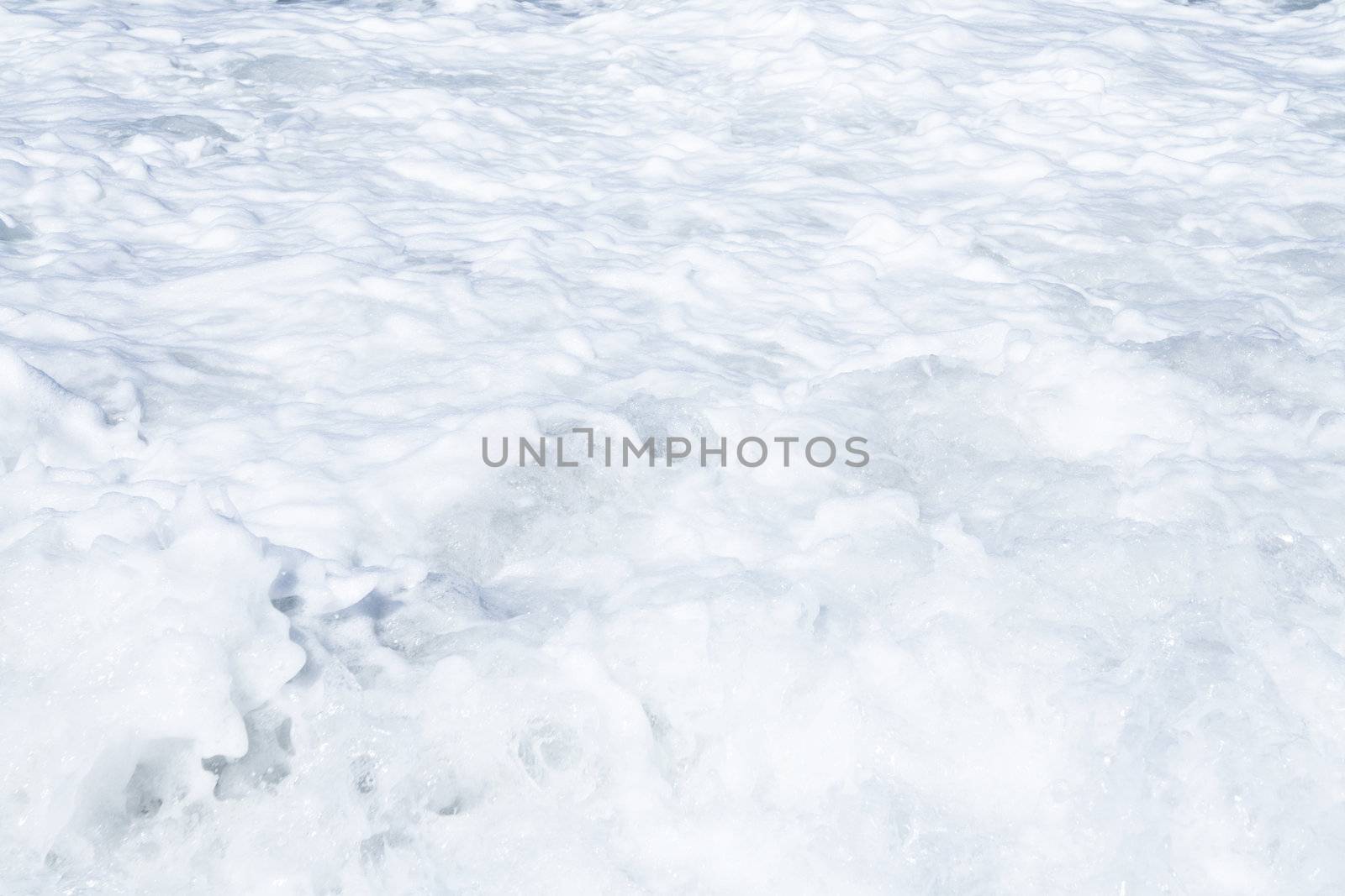 Foamy waves of ocean as a natural background