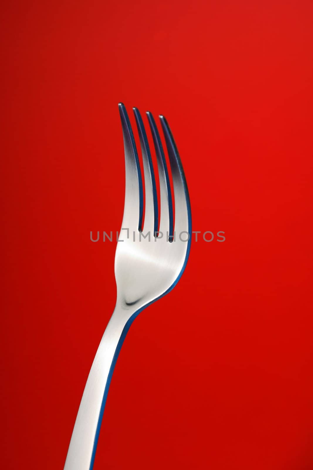 a fork against red background