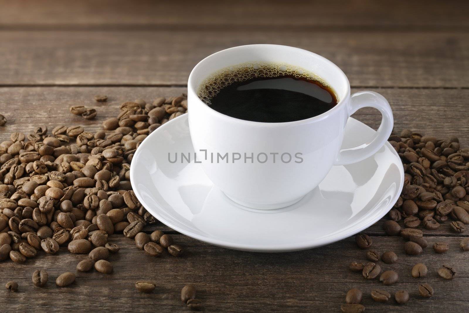 A Cup of coffee with some coffee beans