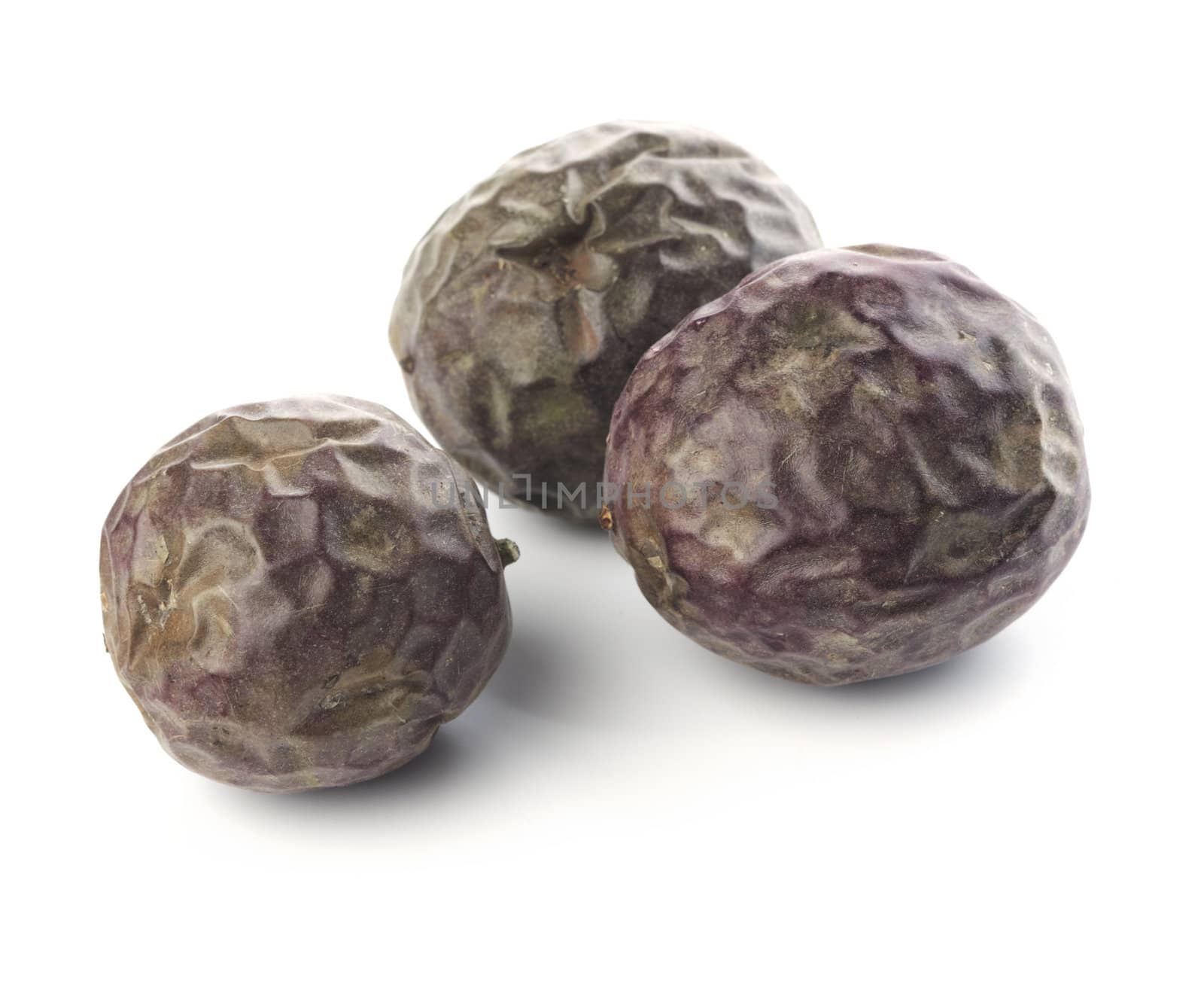 Three passion fruits isolated on white with natural shadows.