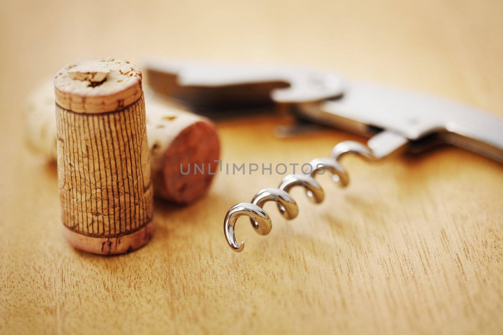 corkscrew and a couple of corks. short depth-of-field.