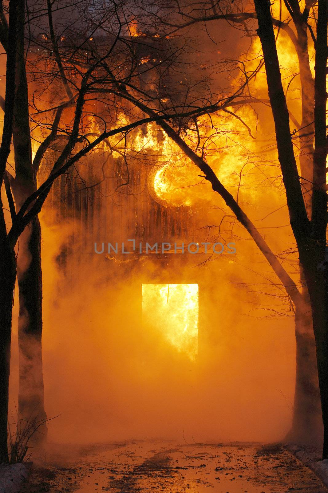 Old wooden house burning in flames