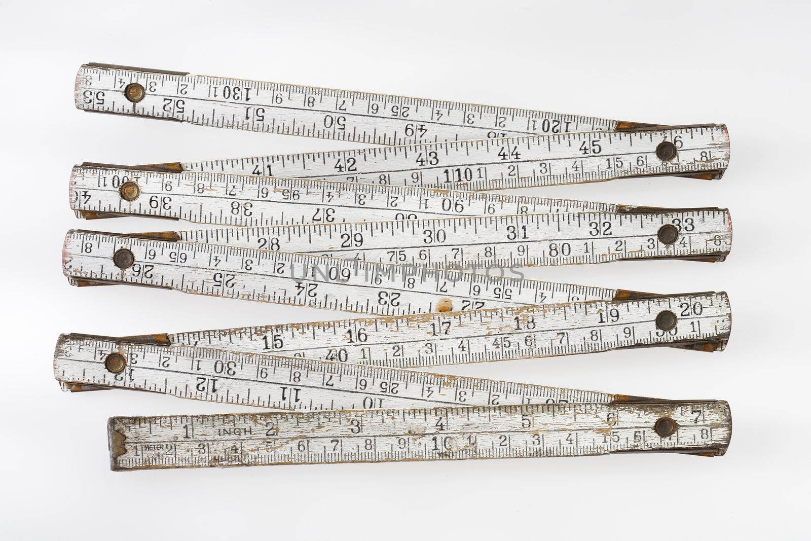 Old and dirty folding carpenter's ruler on light grey background