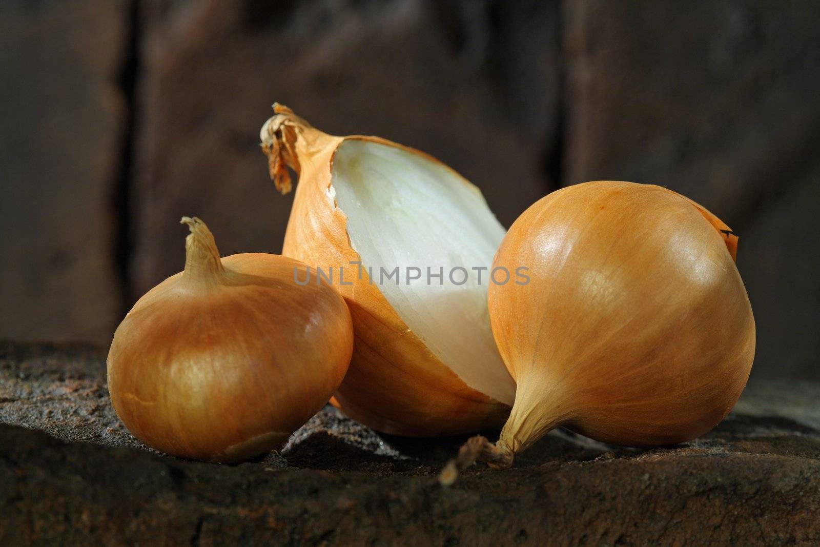 Onions on a brick surface. Short depth of field.