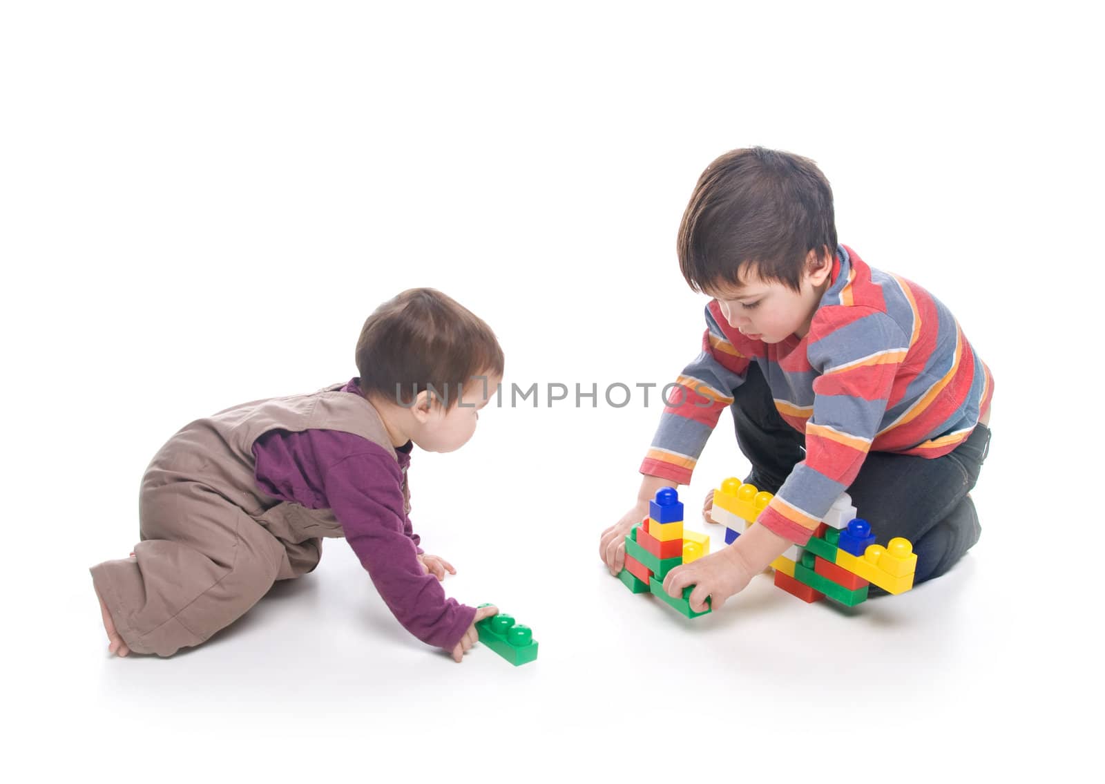 Brother and sister playing together over white background