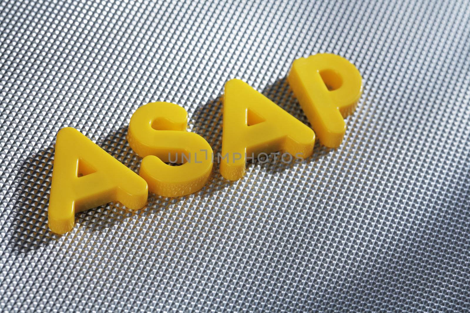 Word ASAP (acronym for As Soon As Possible) written with yellow plastic letters