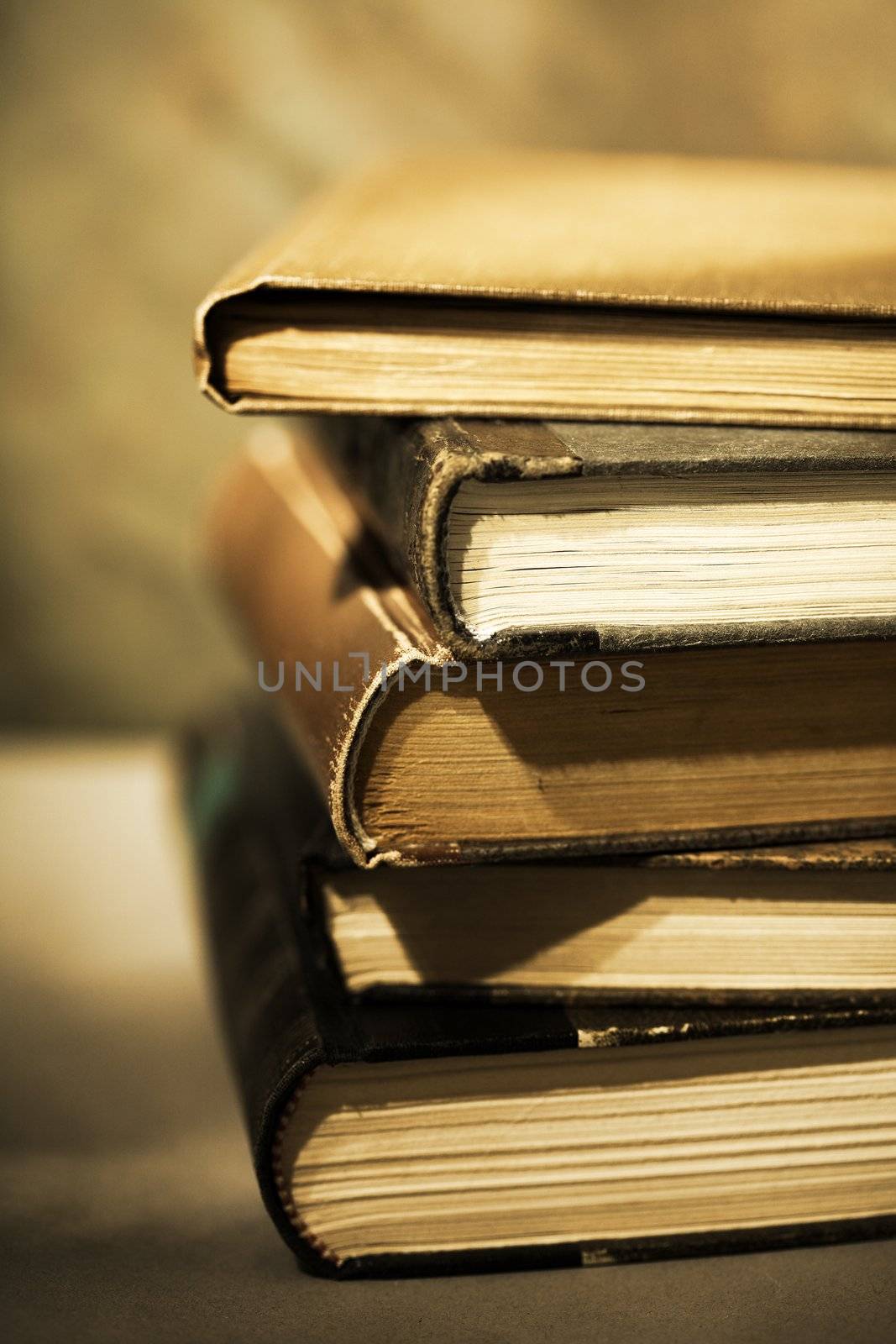 Sepia toned image of stacked books.