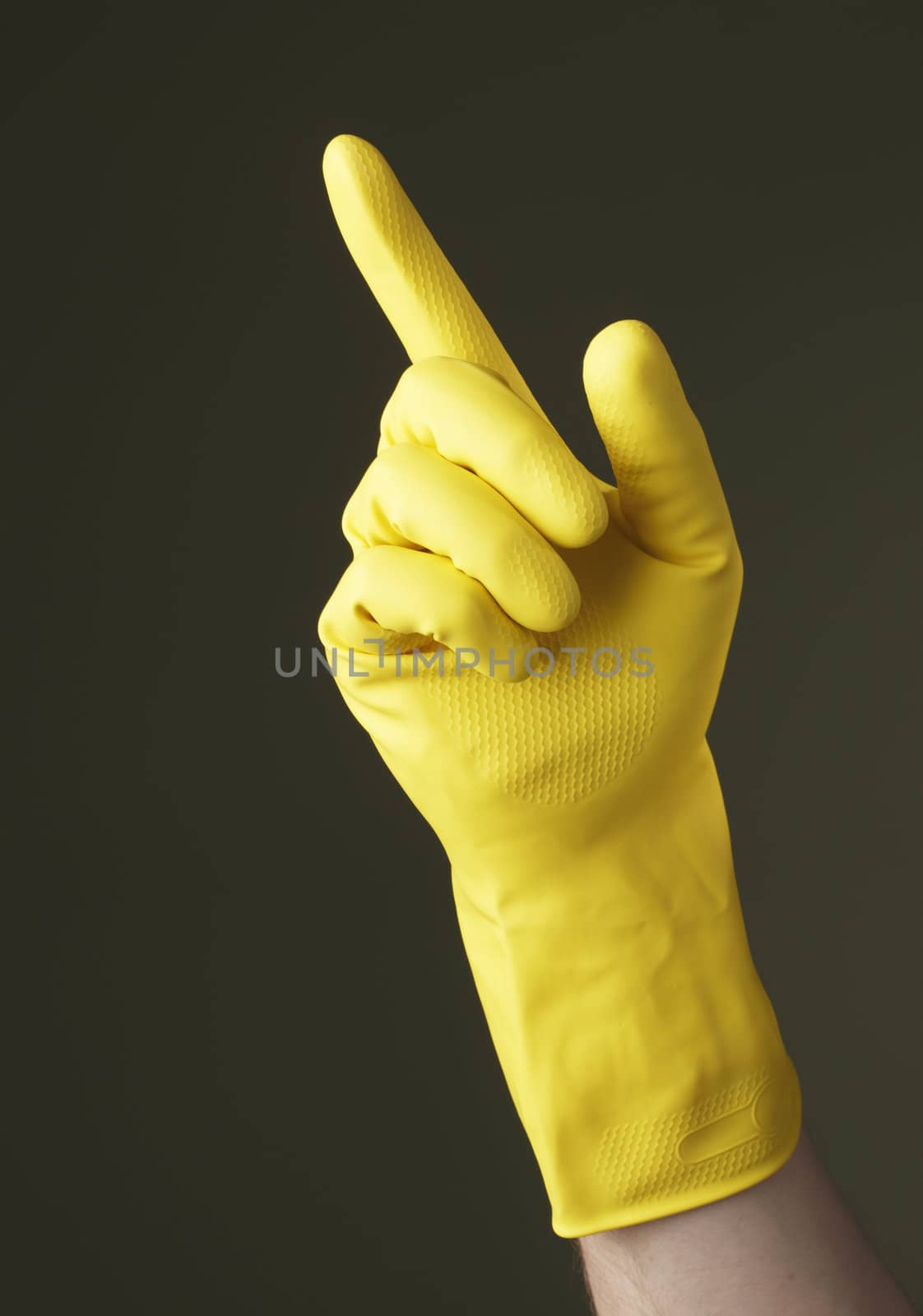 A Hand with yellow protective glove pointing with a finger