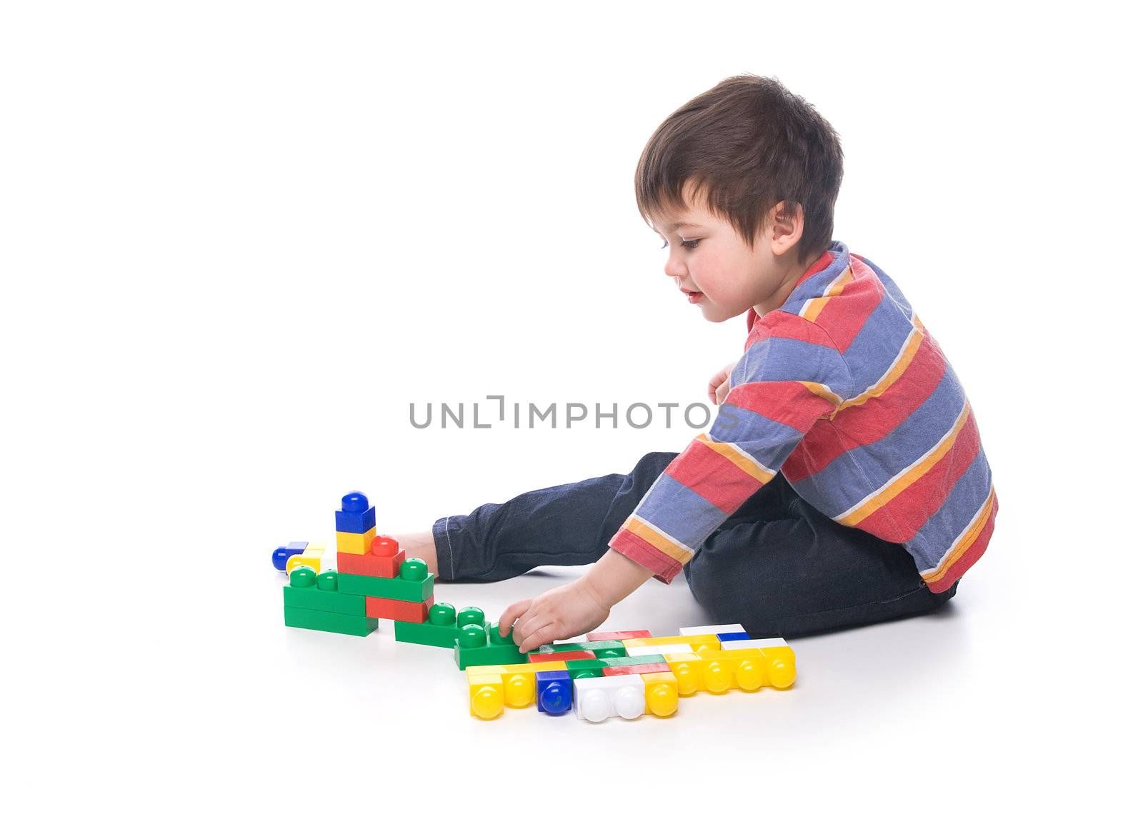 A toddler playing with a multicolored bricks