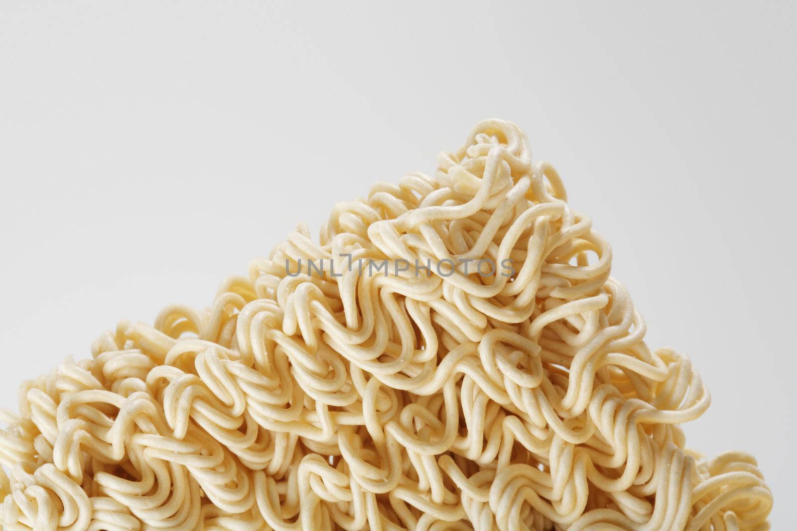 uncooked instant ramen noodles on grey background