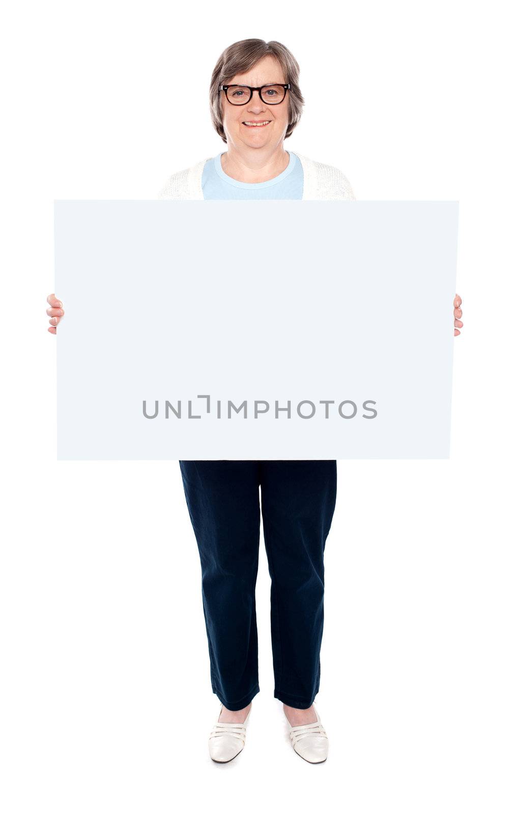 Smiling old lady holding blank whiteboard. Full length portrait