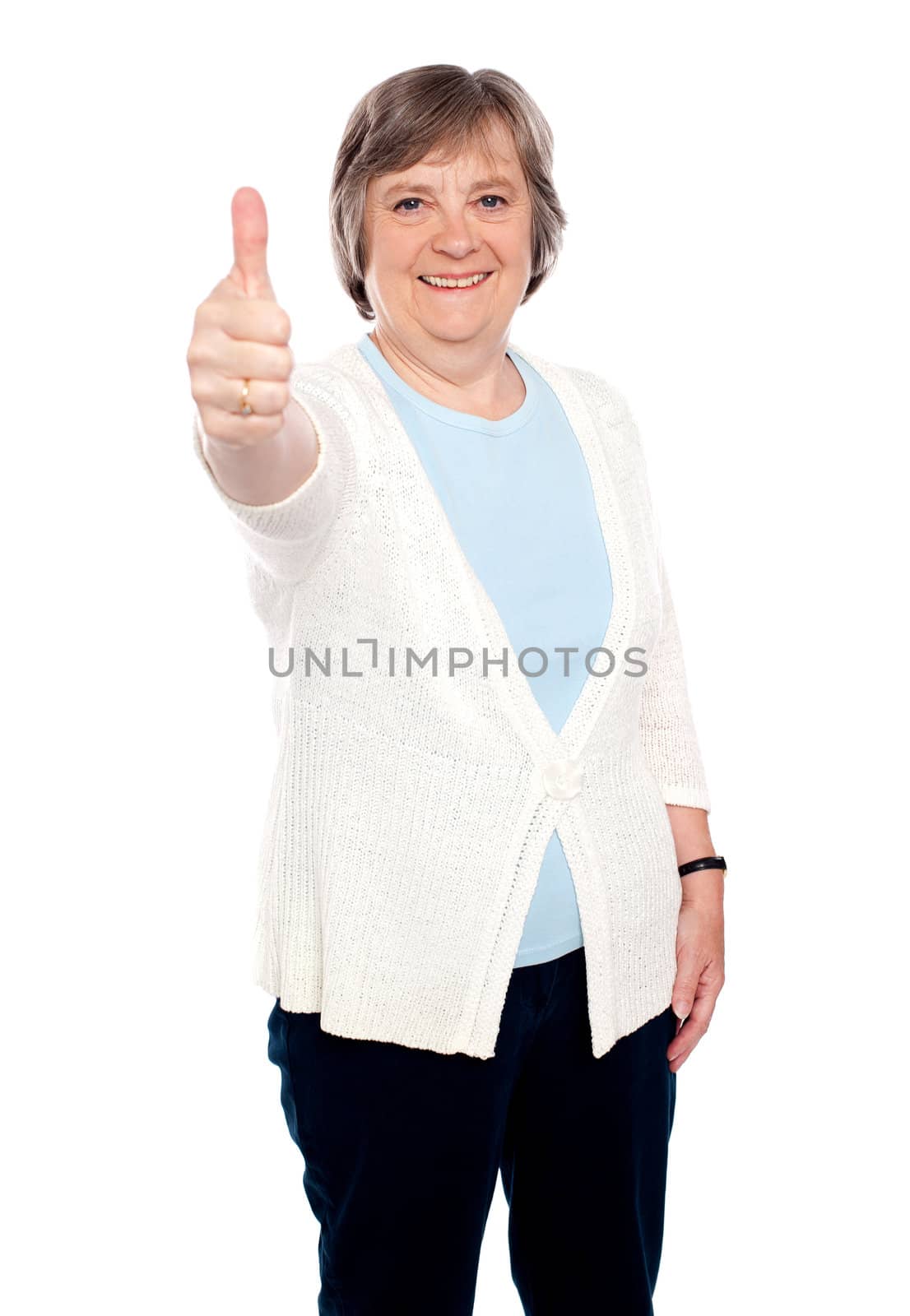 Smiling old lady showing thumbs up gesture to camera. Isolated on white