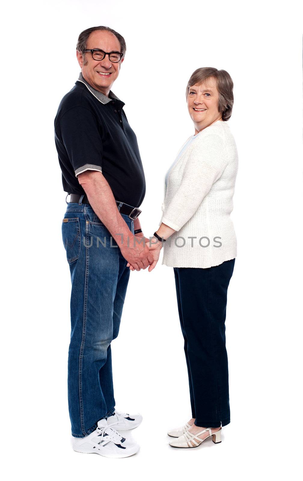 Love couple holding hands. Full length shot isolated over white