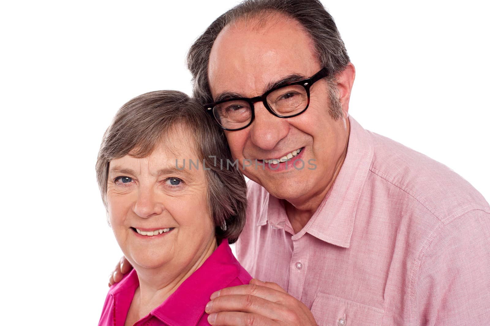 Closeup portrait of smiling aged couple by stockyimages