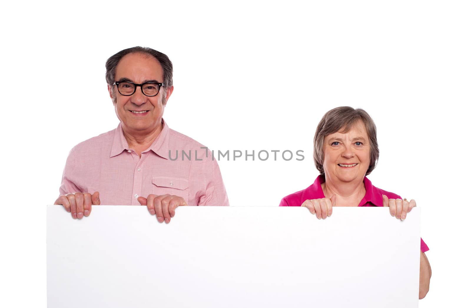 Aged couple displaying blank billboard isolated over white background