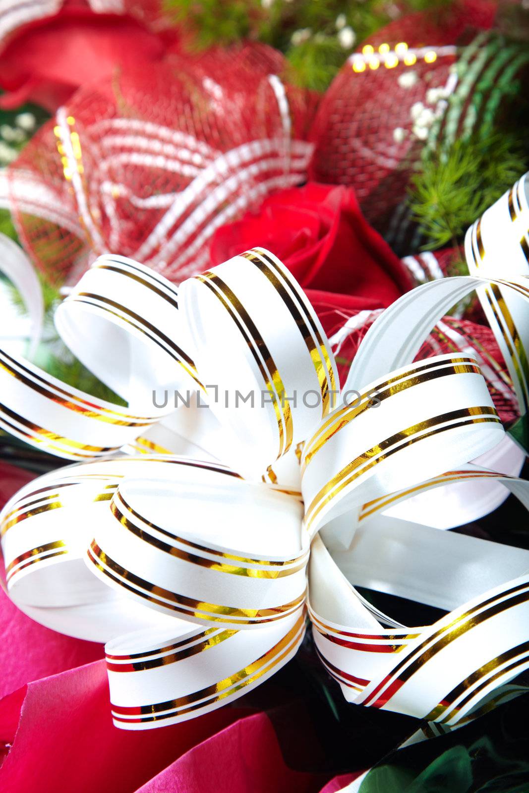 Holiday white ribbon on the bunch of flowers