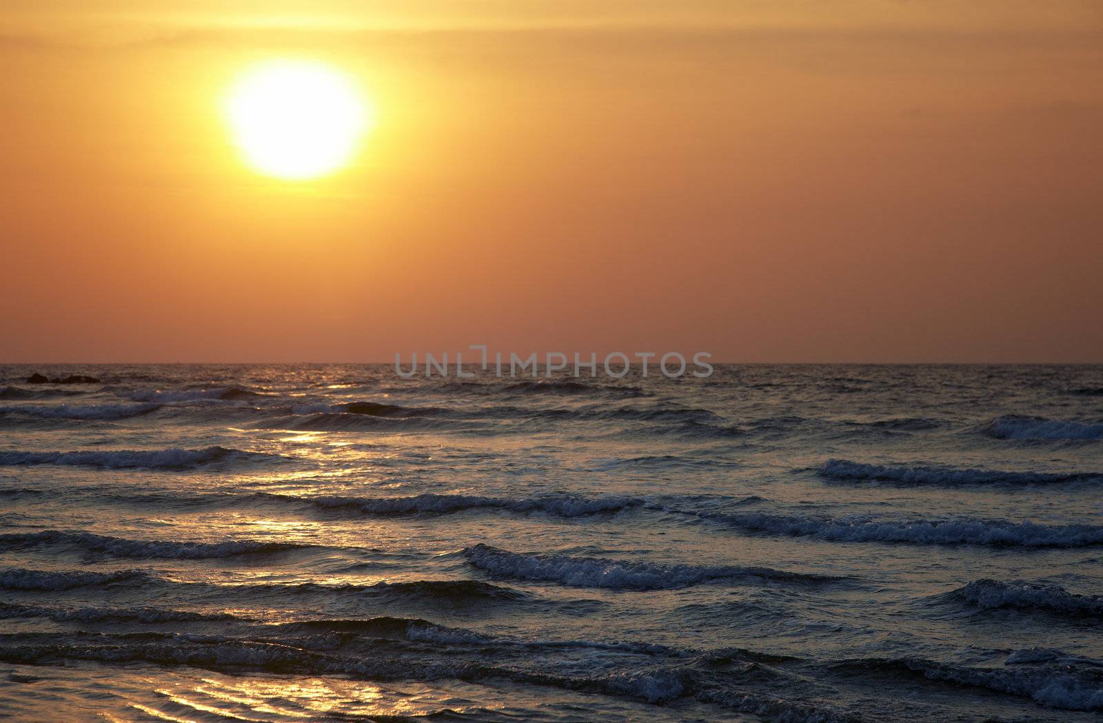 Horizontal photo of the sea during sunset. Natural colors and darkness of twilight