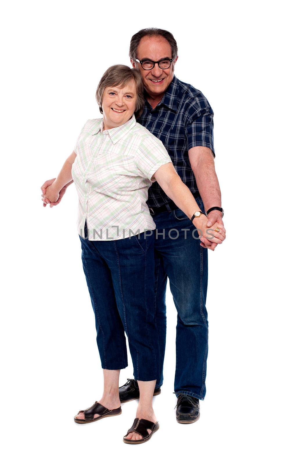 Senior couple in love. Posing in style with hands held together
