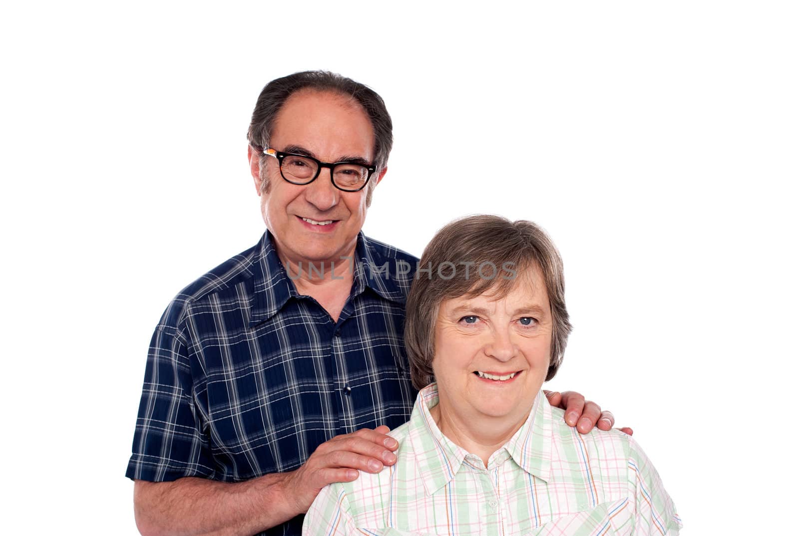 Portrait of smiling matured couple. Man resting his hands on wife's shoulders