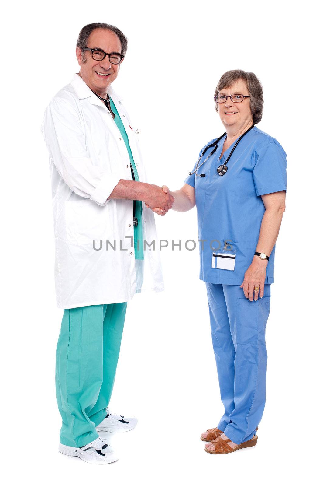 Senior medical persons shaking hands by stockyimages
