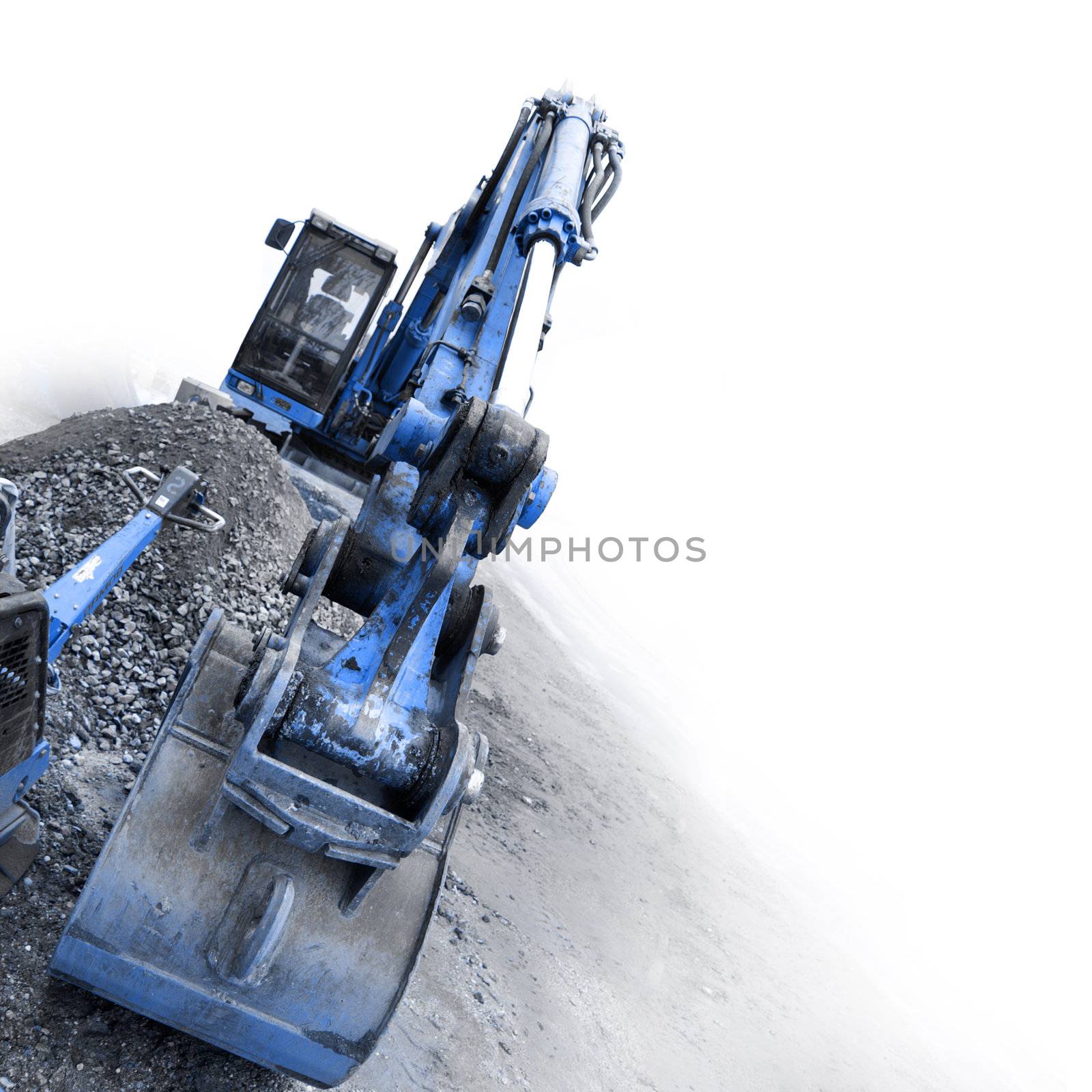 backhoe digging small stones by photochecker