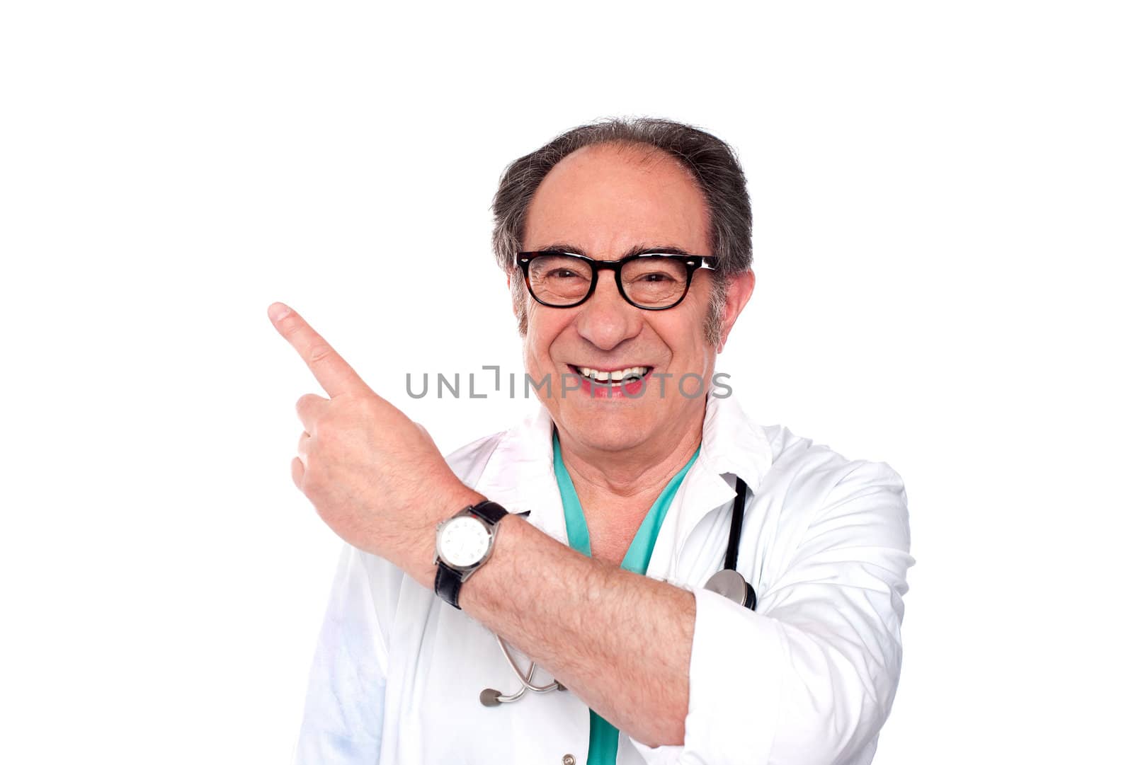 Mature doctor pointing upwards and away. Facing camera, smiling
