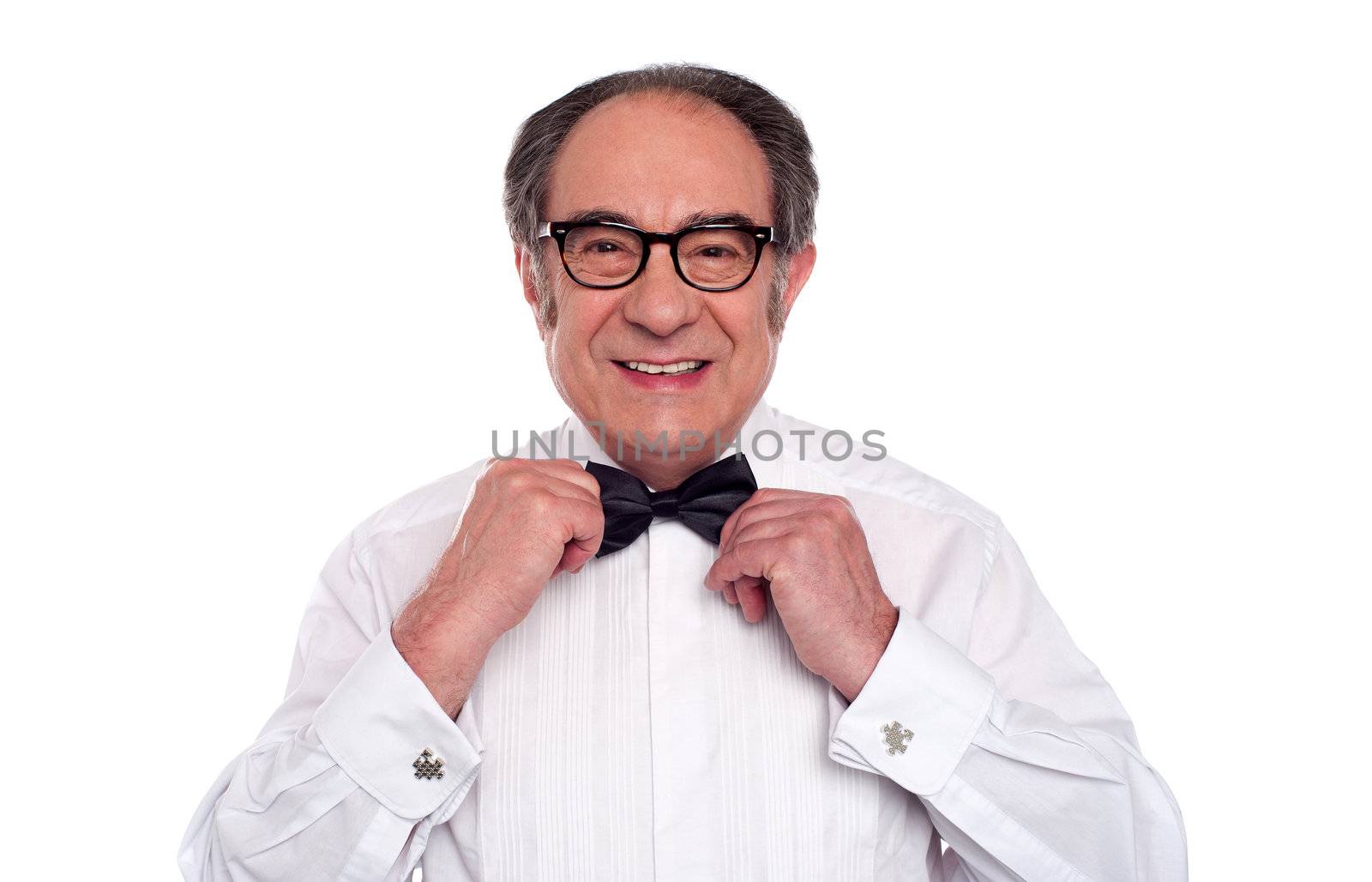 Aged caucasian male adjusting his bow. Wearing ceremony shirt