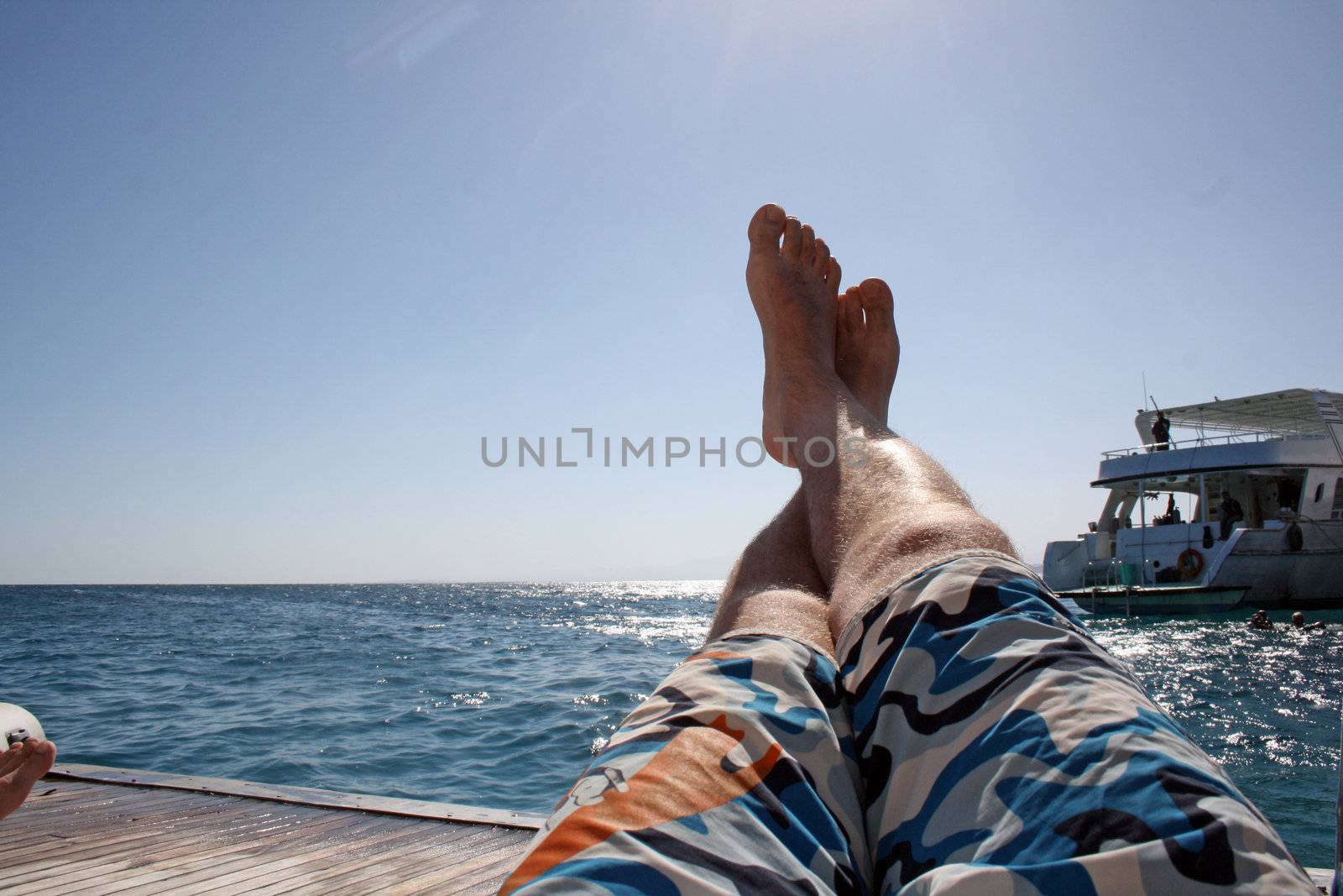 man relaxes on the open sea by photochecker