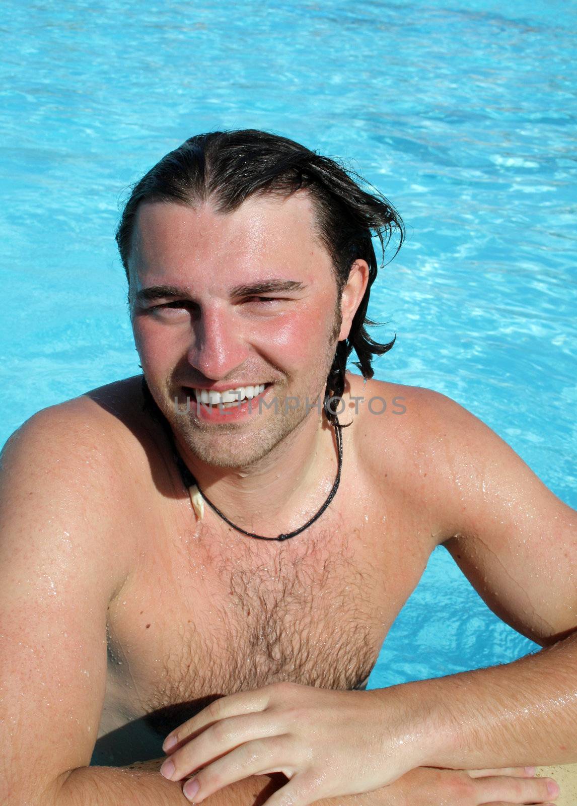 Man posing in pool by photochecker