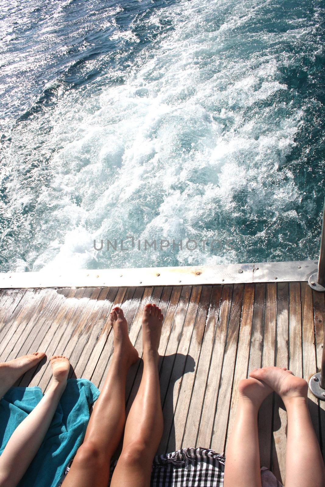 people sunning themselves on deck by photochecker