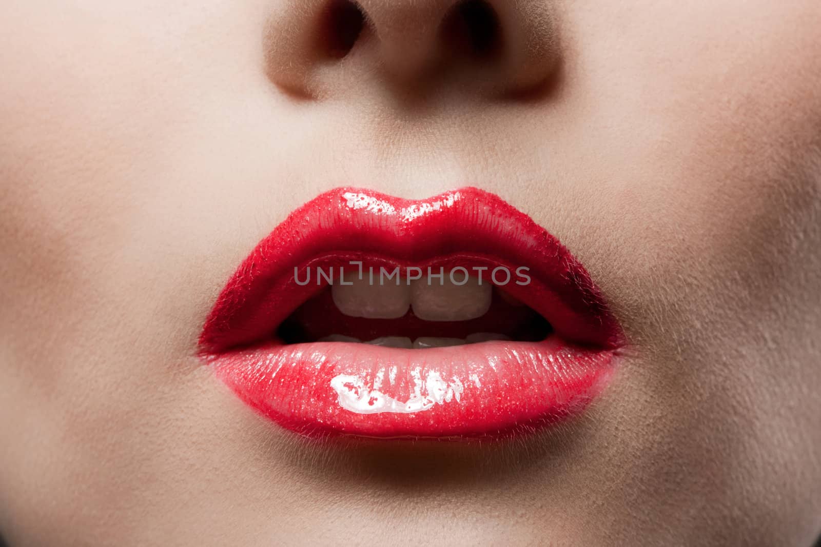 Women's red lips close-up with smooth skin.