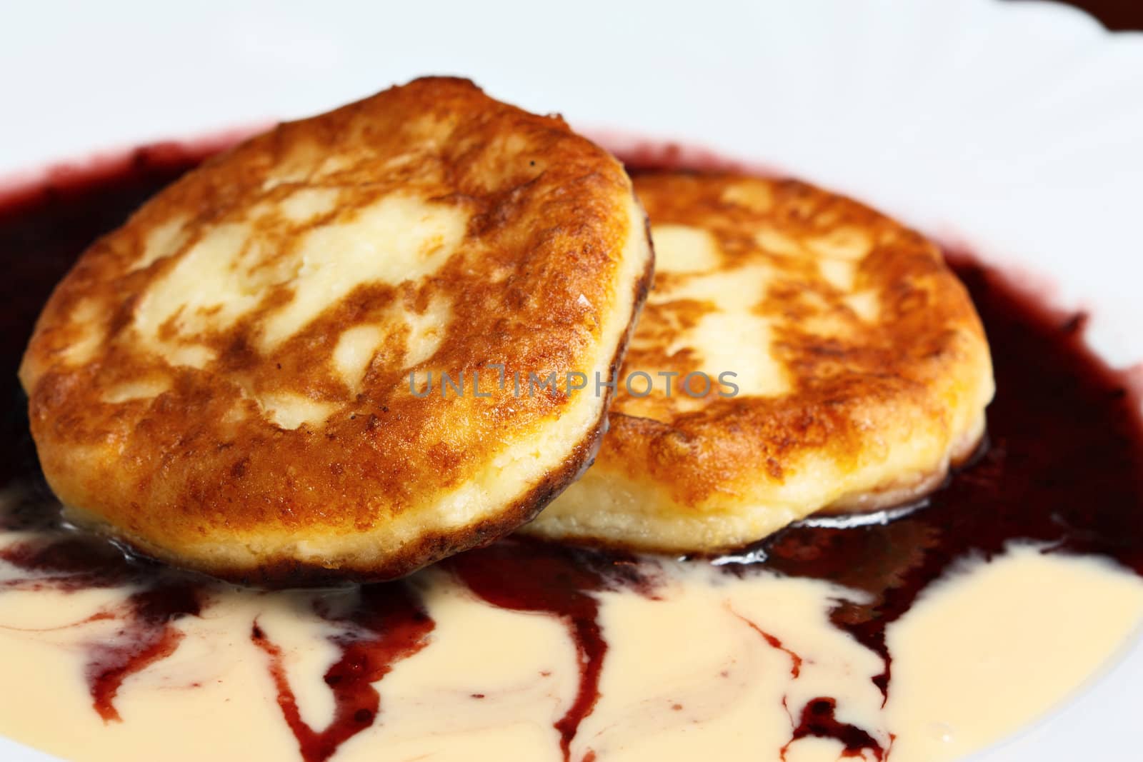 pancakes on a white background with jam.
