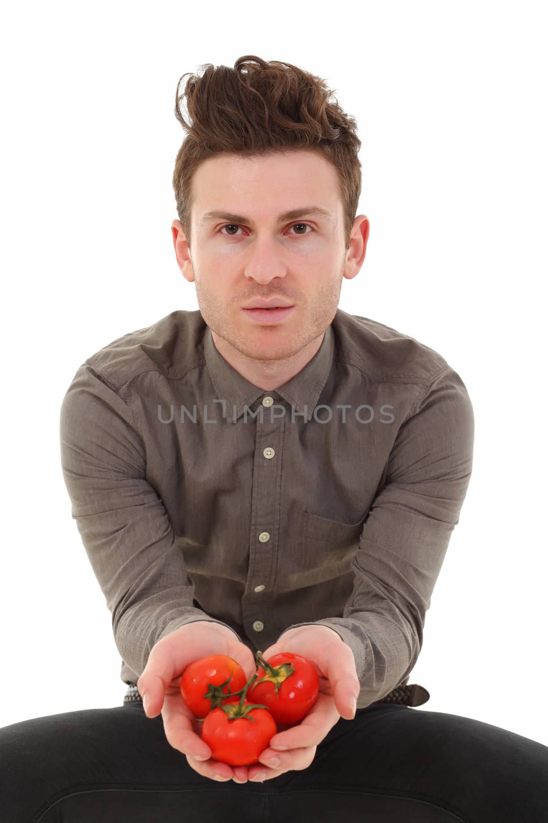 Young man offering tomatoes by shamtor
