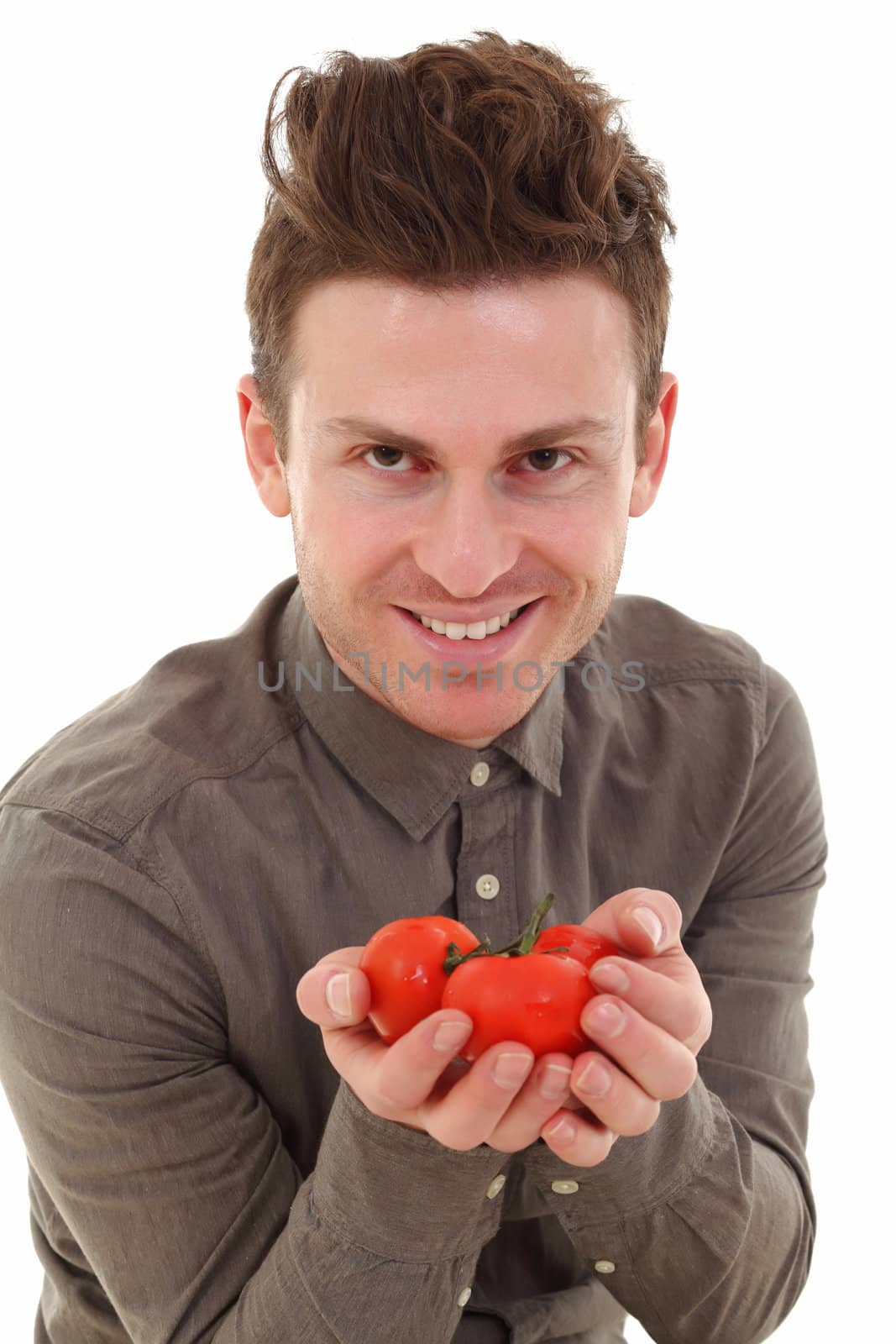 Young man isolated offering tomatoes