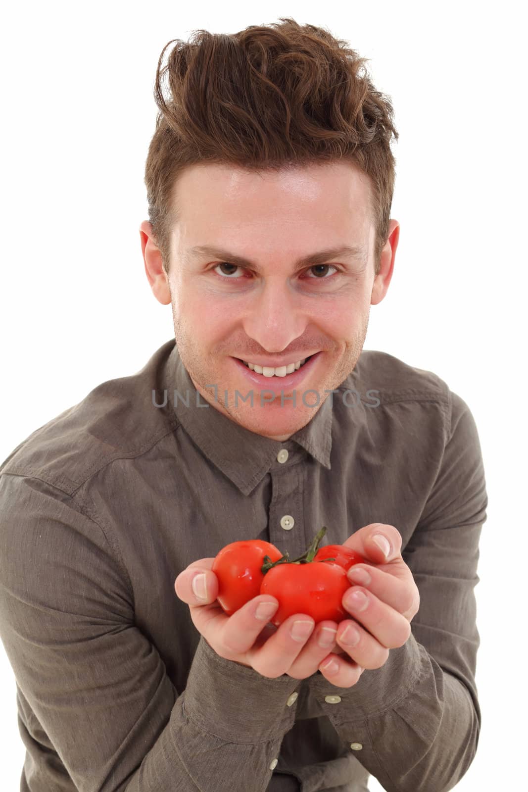 Young man offering tomatoes by shamtor