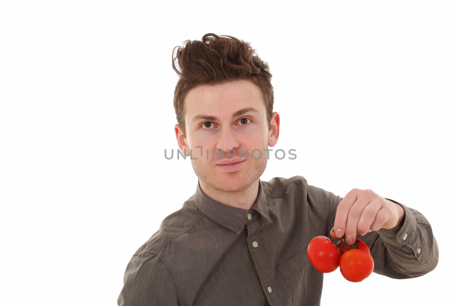 Portrait of young handsome man with tomatoes