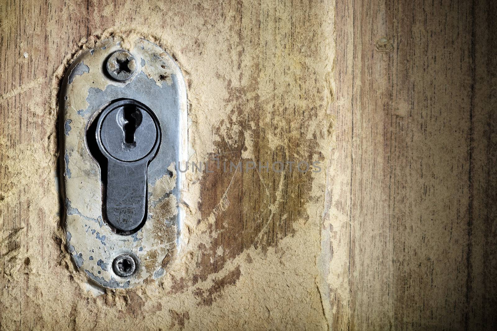 Close-up photo of the old keyhole on the olden door