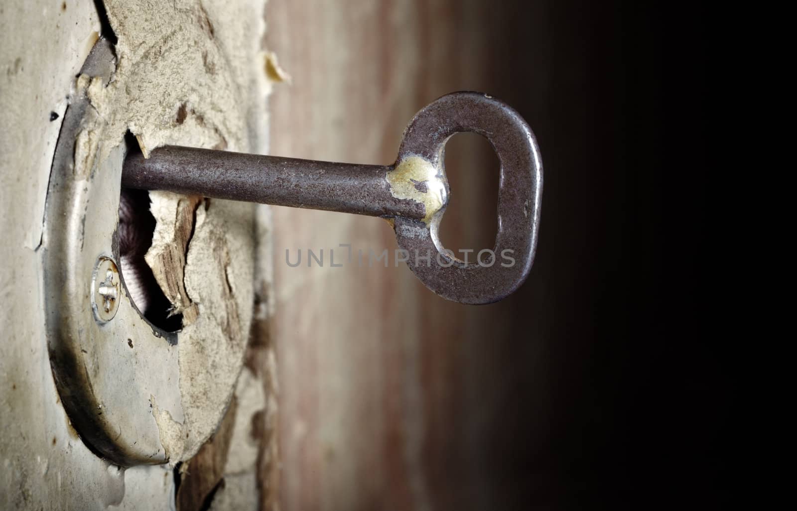 CLose-up photo of the old key inserted into the damaged lock