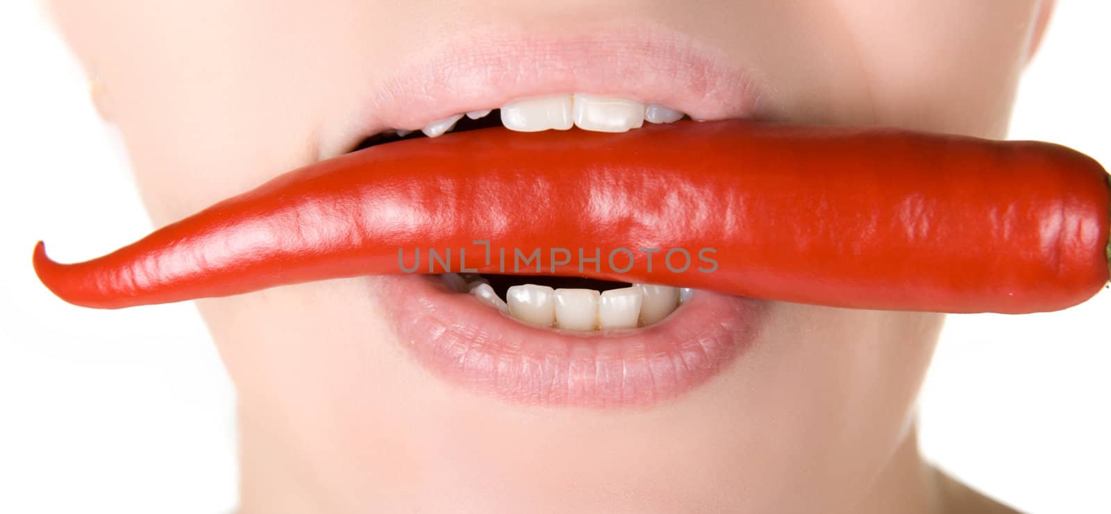 girl close up with chili pepper at her lips isolated on white