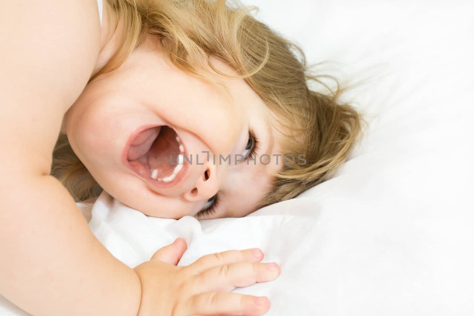 Smiling little girl on a bed