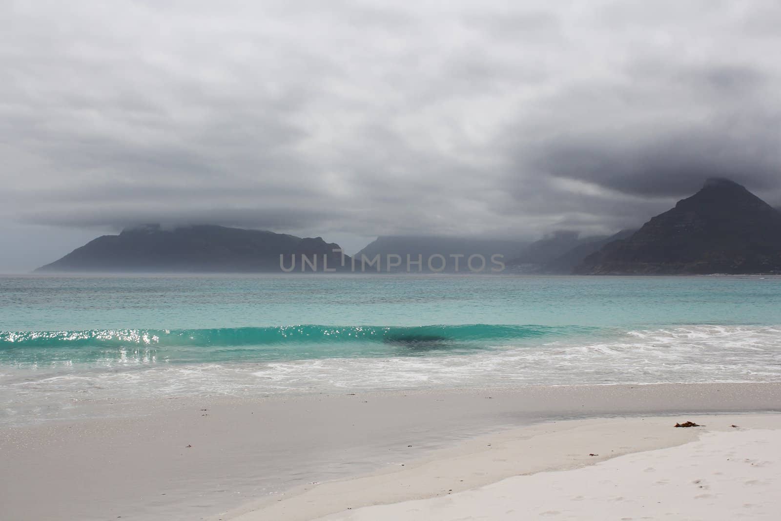 Beach of Kommetjie with an upcoming storm in the background by dwaschnig_photo