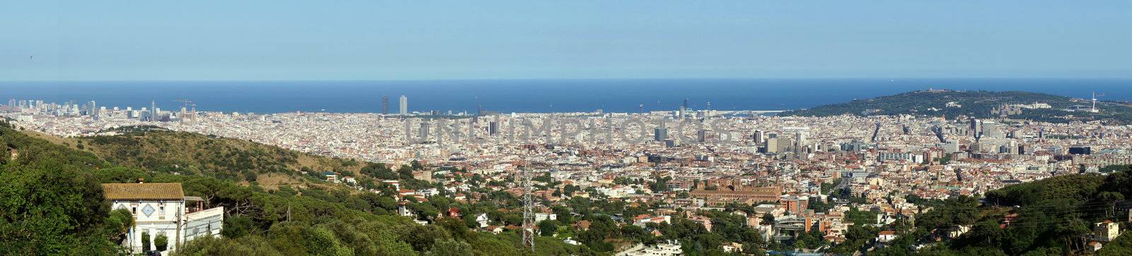 Wide panorama of Barcelona city at the Mediterranean Sea.               