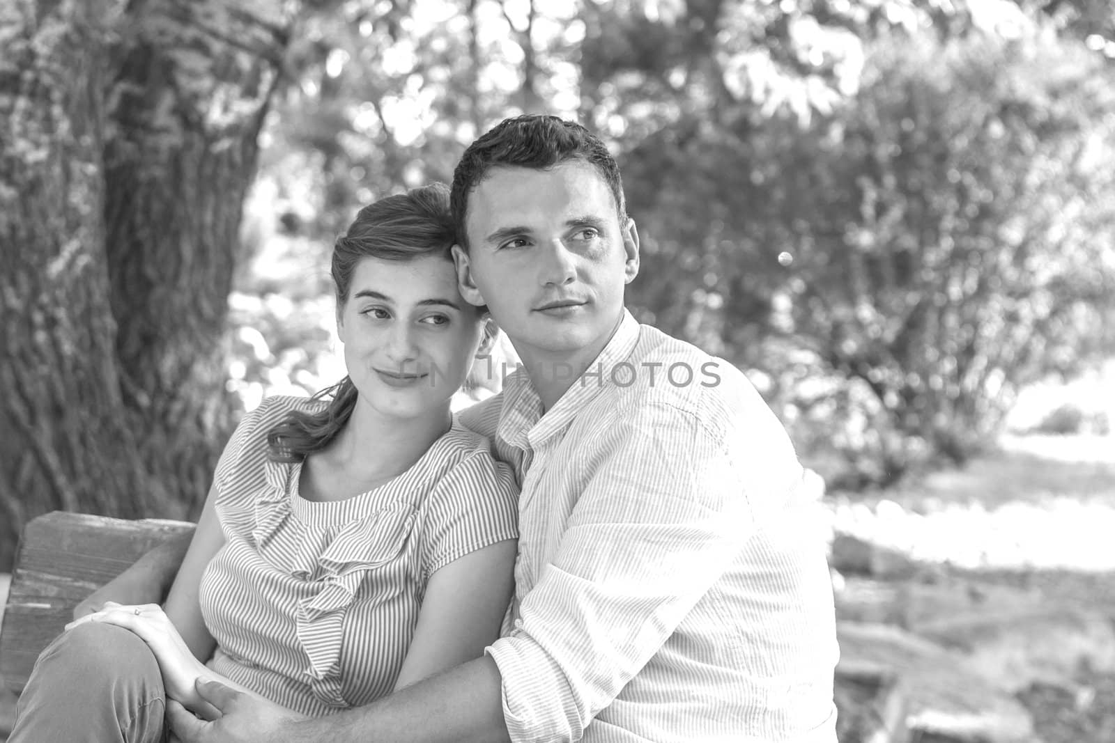 Young couple relaxing in park on a bench