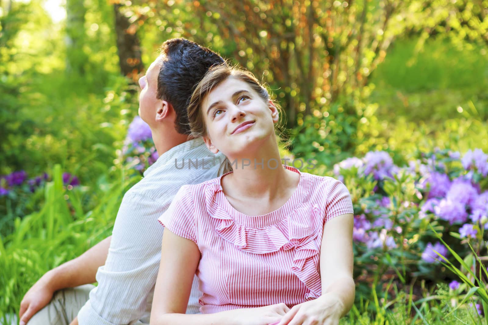 Young couple relaxing in park by manaemedia