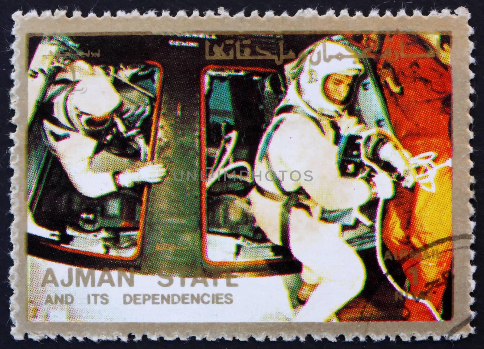AJMAN - CIRCA 1973: a stamp printed in the Ajman shows Astronauts and Command Module, Space Exploration Program, Apollo, circa 1973